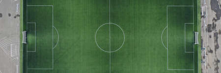 Large green football field at stadium closeup