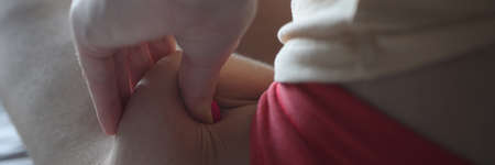 Woman making fold of fat on skin of her leg with cellulite closeup