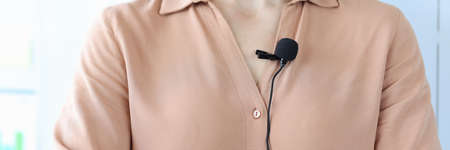 Small black microphone attaching to woman shirt closeupの写真素材