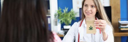 Doctor holds paper bag with marijuana in front of patient