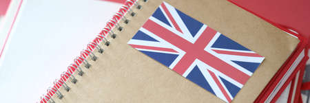Stylish notepad with britain flag and copybooks on tableの写真素材
