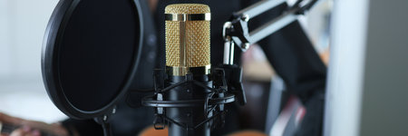 Gold modern professional studio microphone closeup backgroundの写真素材