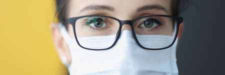 Portrait of woman with eyeglasses and protective maskの写真素材