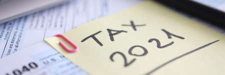 Tax form for 2021 calculator and document are on tableの写真素材