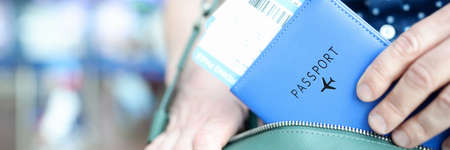 Man takes out of his bag plane tickets with passport