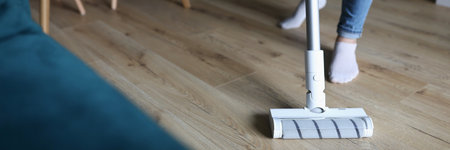 Woman washes floor with mop. Services of cleaning companiesの写真素材