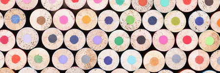 Closeup of many unsharpened multicolored wooden pencils backgroundの写真素材