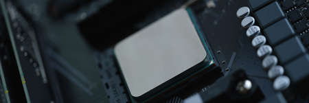 Computer processor in silver is installed in motherboard closeupの写真素材