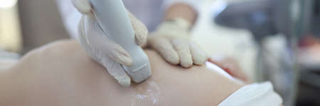 Doctor doing ultrasound examination of woman breast closeup