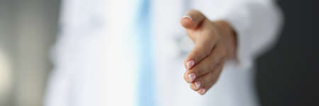 Doctor holds out his hand for handshakeの写真素材