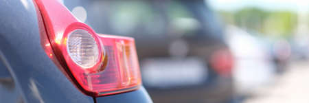 Rear red light on black car closeupの写真素材