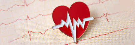 Result of electrocardiogram with icon lies on table