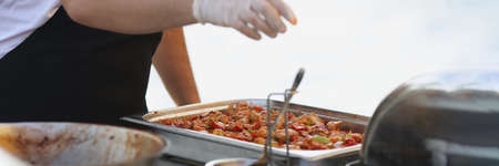 Chef in rubber gloves preparing food in restaurant closeupの写真素材