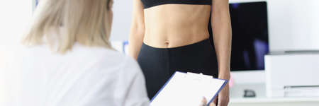 Woman doctor examining patient in clinic closeup