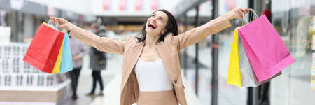 Happy joyful woman with purchases in mall closeupの写真素材