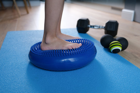 Child foot is resting on blue massage balancing cushion closeupの写真素材