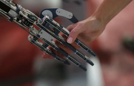 Woman shaking hand with metal prosthesis closeupの写真素材