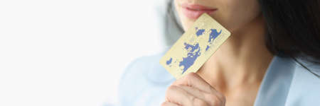 Young businesswoman is holding plastic bank card closeupの写真素材