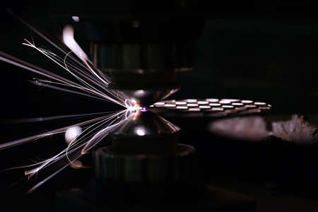 Closeup of laser head cutting iron sheetの写真素材