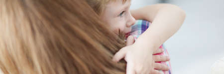 Mom holds little girl in her armsの写真素材