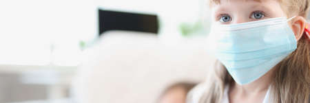 Portrait of little girl in medical protective maskの写真素材