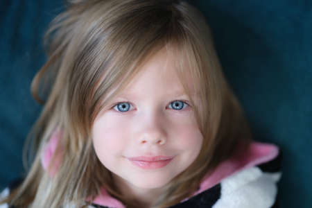 Portrait of beautiful cute little girl with blue eyeの写真素材