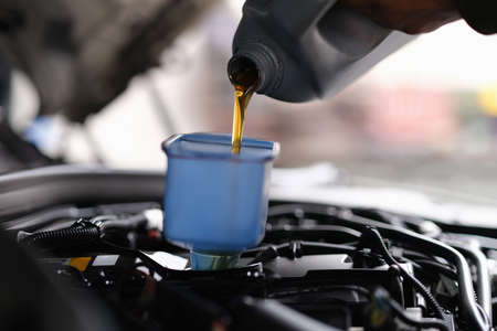 Machine oil for a car is poured into a containerの写真素材