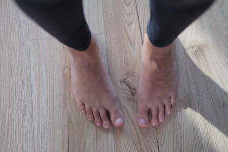 Feet of female legs, close-up. Standing barefoot on the floorの写真素材