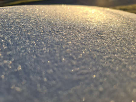 Bright sunlight on white frosty surface background