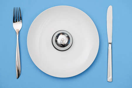 Bell on plate with fork and knife