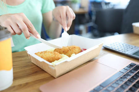 Woman eats in the dining room, disposable tablewareの写真素材