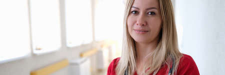 Portrait of young woman doctor in hospital corridor