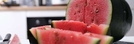Large ripe juicy sliced watermelon on table closeup