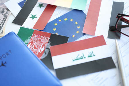 Flags of African and Asian countries lying around EU flag closeupの写真素材