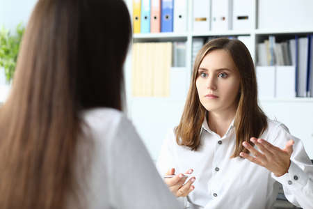Portrait of smart businesspeople sitting in modern workplaceの写真素材
