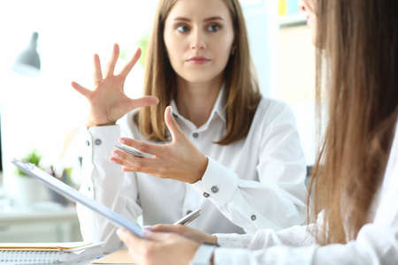 Portrait of concerned businesswoman sitting in modern workplaceの写真素材