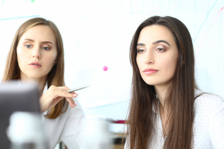Portrait of smart businesswoman sitting at comfortable workplaceの写真素材