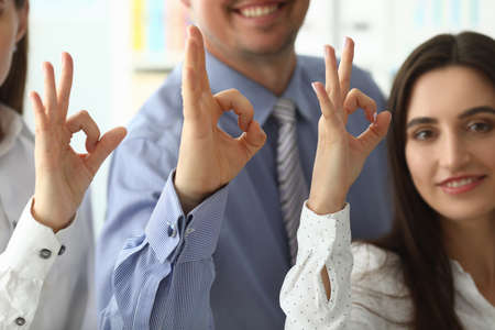 Focus on tender female and male hands showing ok gesture and posingの写真素材