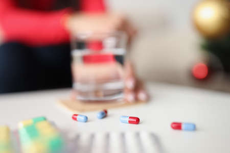 Jelly capsules scattered on table daily dose of medication for personの写真素材