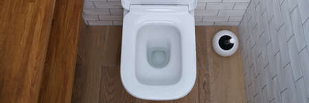 White open ceramic toilet in bathroom. Choice of plumbing in toilet