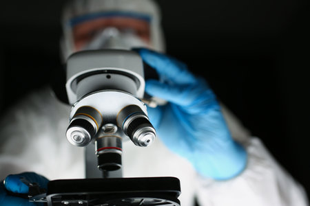 Professional scientist using equipment in modern laboratory while examining new chemical formula