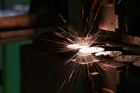 Sparks fly out machine head for metal processing laser metal