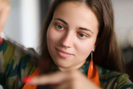 Brunette woman master at beauty salon do haircut with full involvement
