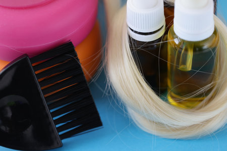 Bottles with cosmetics for hair care and brush to dye hairの写真素材