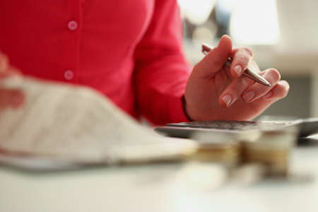 Woman calculating total amount of expense at end of monthの写真素材