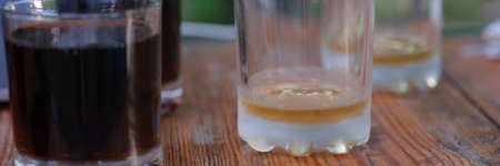 Glasses of whiskey and beer are on table in bar closeup