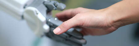 Closeup of handshake of female hand and artificial prosthesisの写真素材