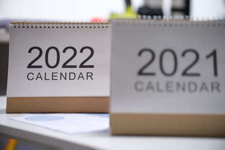 Looseleaf paper calendars for 2021 and 2022 standing on table closeupの写真素材