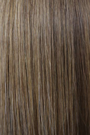 Straight chestnut natural hair texture after dye procedure in salonの写真素材