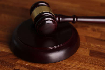 Judges wooden hammer on soundboard placed on wooden table
